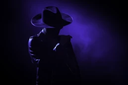 José James performing live at Ancienne Belgique Brussels on October 1 2024, silhouetted against dramatic purple stage lighting. Concert photography by Marvin Anthony.